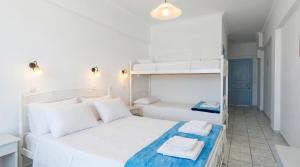 a bedroom with two beds and a bunk bed at Lume d'Oro Syros in Kini