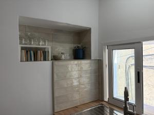 a kitchen with a window and a sink and a counter at El Redoble de Moratalla in Moratalla +39 photos