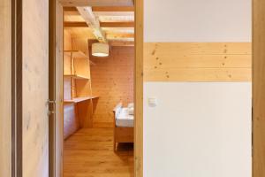 a small room with a bed and a hallway at Schwabl Auf Der Ebene in Meltina +106 photos