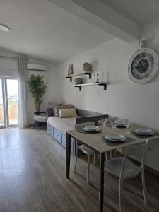 a living room with a table and a couch at Villa Crown Silvia in Dobra Voda
