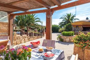 a table with a plate of food on a patio at Résidence Villa Smeralda in Telti