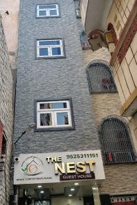 a tall brick building with a nest guest house at The Nest Kashi in Varanasi