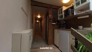 a small room with a kitchen and a hallway at Pension Martin Zimmer & Apartment in Bad Camberg