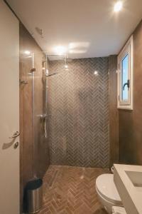a bathroom with a shower and a toilet at The Real Sea View Hotel Vlore in Vlorë