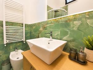 a bathroom with a sink and a toilet at Maison Arche' relax e spazio a Sannicandro in Sannicandro di Bari +28 photos