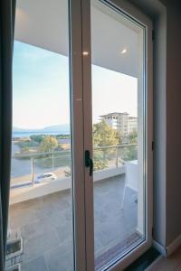 a sliding glass door with a view of a balcony at The Real Sea View Hotel Vlore in Vlorë