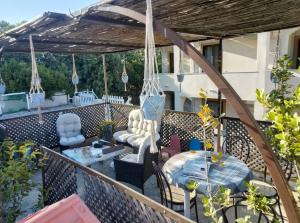 a patio with a table and chairs on a balcony at Chios Panorama in Karfas