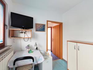 a room with a desk with a tv on the wall at Rooms Čehovin in Postojna