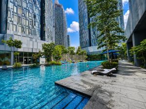 a large swimming pool in a city with tall buildings at STAR Residence KLCC - Dreamland Holiday Home in Kuala Lumpur