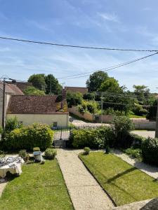a view of a garden from the roof of a house at Chambre d'Hôte des Arcs in Coulonces