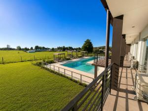 a view of the pool from the balcony of a house at Hotel Cardal Tandil in Tandil