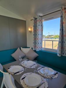 a dining room with a table and a window at Maria Meco in Sesimbra