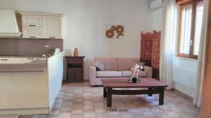a living room with a couch and a coffee table at Appartamento Mancaversa Centro, 200m mare in Marina di Mancaversa
