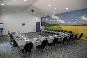 a conference room with tables and chairs and a large screen at Boutique Hotel Ukus in Tešanj +88 photos