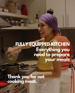 a woman standing in a kitchen preparing food at Casa Caravan - Plant Based Concept House in Buenos Aires