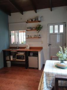 a kitchen with a counter and a sink and a table at La Adelita in Chascomús