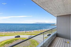 a view of the ocean from the balcony of a building at Premium Ice Apartments Atlantic Ocean Magic View in Reykjavík