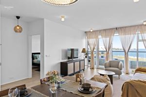 a living room with a couch and a table at Premium Ice Apartments Atlantic Ocean Magic View in Reykjavík