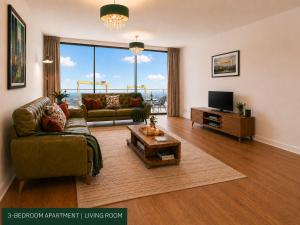 a living room with a couch and a television at CK Serviced Apartments, Titanic Quarter, Belfast in Belfast