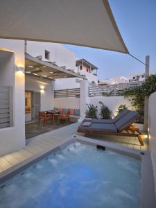 a house with a swimming pool and a patio at Kandiani Bleu Ciel in Naousa