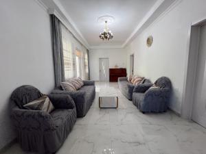 a living room with two couches and a table at Resort In Gonio in Kvariati