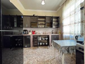 a kitchen with a counter and a table in it at Resort In Gonio in Kvariati +13 photos