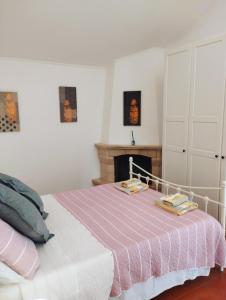 a white bedroom with a bed and a fireplace at Casa dos Cavalos in Sertã +48 photos