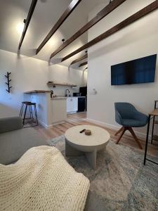a living room with a couch and a table at Cabin Oasis near Town in Catskill