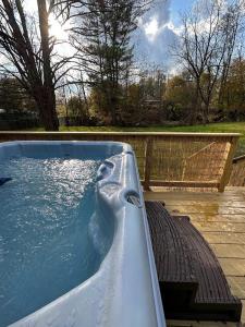 a hot tub with water in it in a yard at Cabin Oasis near Town in Catskill