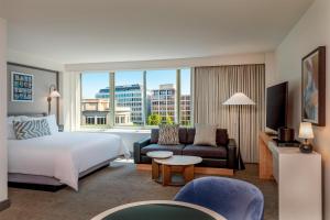 a hotel room with a bed and a large window at The Beacon at Embassy Row, WorldHotels Distinctive in Washington, D.C.