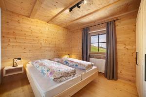 a bedroom with a bed in a wooden room at Innerdurachhof in Santa Valpurga