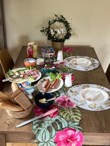 a wooden table with plates of food on it at BIZAR Hostel in Sadowa