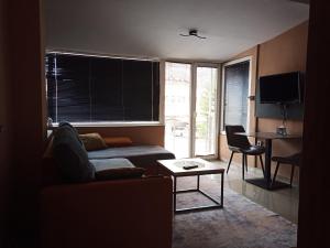 a living room with a couch and a table at Urban Boutique Apartments in Bitola