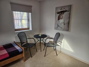 a room with a table and chairs and a bed at Občerstvení u cyklostezky in Břehov