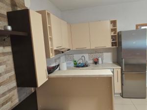 a kitchen with white cabinets and a stainless steel refrigerator at Apartman Daniela in Neum