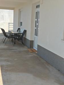 a patio with a table and chairs in a building at Apartman Daniela in Neum +13 photos