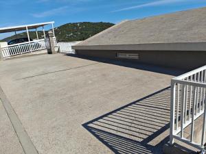 a ramp to a building with a white railing at Apartman Daniela in Neum