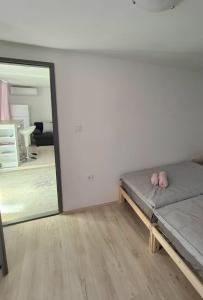 a bed in a room with a large mirror at C&M Studio Apartment in Rijeka