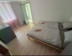 a bedroom with a bed with two pink pillows on it at C&M Studio Apartment in Rijeka