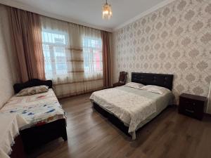 a bedroom with two beds and a window at Resort In Gonio in Kvariati