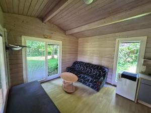 a living room with a couch and a table at Giruliu kopa in Melnragė