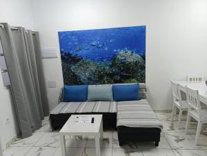 a living room with a couch and a painting on the wall at VV Abrante in La Restinga