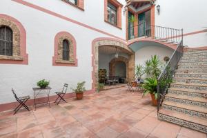 a courtyard of a house with a staircase at Can Lluís in Capellades