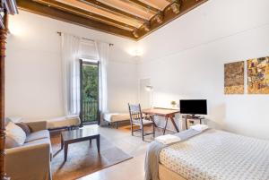 a bedroom with a bed and a living room at Can Lluís in Capellades