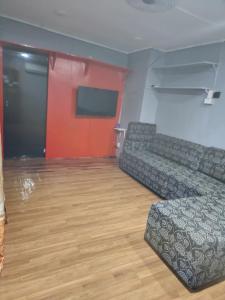 a living room with a couch and a flat screen tv at Aaqib Homestay in Suva +3 photos