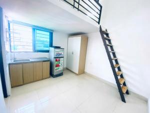 a kitchen with a stairs leading to a kitchen with a refrigerator at 46 An Hòa, Mỗ lao in Hanoi