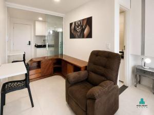 a living room with a chair and a desk at Fortaleza Sul by Holiday Stays in Fortaleza