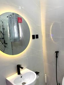 a bathroom with a sink and a mirror at 2 bedroom Atrium apartment in Gwarinpa +10 photos