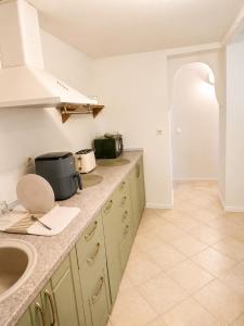 a kitchen with a sink and a counter top at Daisy House Golden Beach Area in Potamiá +18 photos