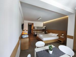 a bedroom with a bed and a table and chairs at ISALOS GERAKiNi in Yerakiní +78 photos